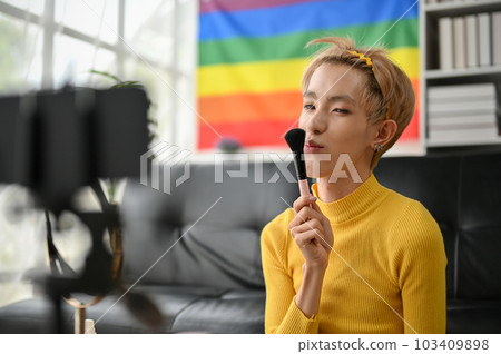 A gorgeous and confident young Asian gay beauty blogger recording his makeup tutorial video 103409898