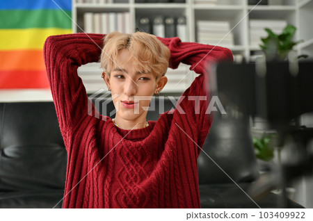 Portrait of an attractive young Asian gay influencer filming his blog through his smartphone Portrait of an attractive young Asian gay influencer filming his blog through his smartphone 103409922