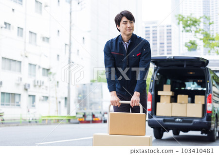 Logistics A delivery person who carries packages on a trolley Logistics A delivery person who carries packages on a trolley 103410481