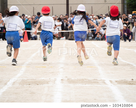 Back view of a child running an elementary school athletic meet / foot race 103410804