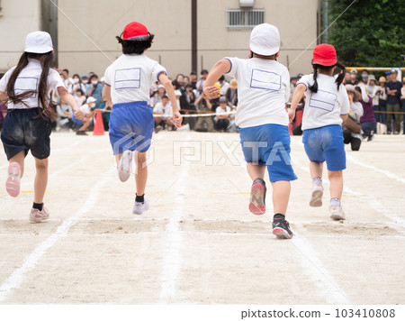 Back view of a child running an elementary school athletic meet / foot race 103410808