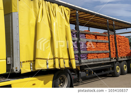 Truck Loaded With Palletized Onion Bags Wrapped in Netting - Transport and Logistics  103410837