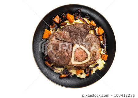 Osso buco cross cut veal shank with mashed potato on a plate. Isolated on white background. 103412258