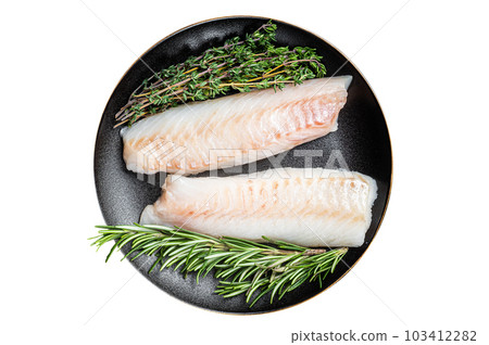 Raw cod loin fillet steaks with herbs on plate. Isolated on white background. Raw cod loin fillet steaks with herbs on plate. Isolated on white background. 103412282