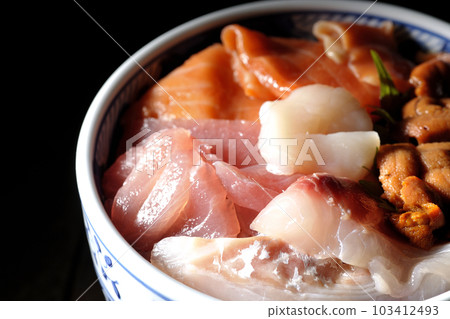Seafood rice bowl with tuna, salmon, sea bream, scallop and sea urchin Seafood rice bowl with tuna, salmon, sea bream, scallop and sea urchin 103412493