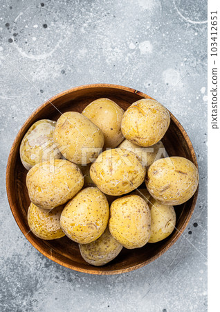 Canarian boiled potatoes papas arrugadas. Gray background. Top view Canarian boiled potatoes papas arrugadas. Gray background. Top view 103412651