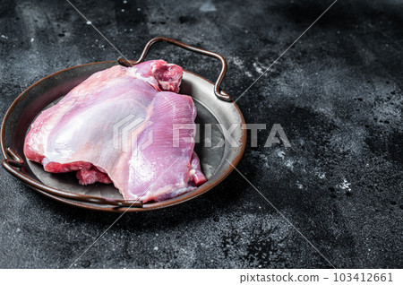 Raw Turkey boneless and skinless thigh fillet. Farm eco meat. Black background. Top view. Space for text Raw Turkey boneless and skinless thigh fillet. Farm eco meat. Black background. Top view. Space for text 103412661
