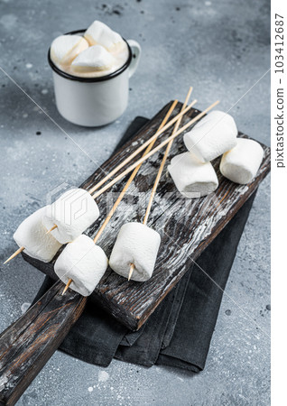 Marshmallow on the stick ready for BBQ. Gray background. Top view Marshmallow on the stick ready for BBQ. Gray background. Top view 103412687