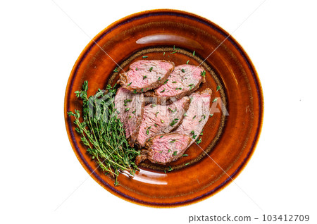 Roast beef tenderloin steak bbq on a rustic plate cutting board. Isolated on white background. 103412709