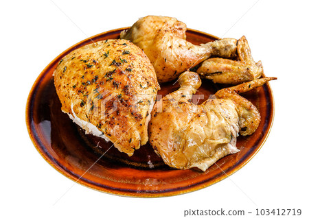 Butchered baked chicken on wooden table. Isolated on white background. 103412719