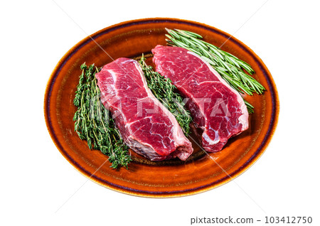 Raw strip loin beef meat steak on a plate with herbs. Isolated on white background. Raw strip loin beef meat steak on a plate with herbs. Isolated on white background. 103412750
