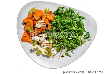Grilled pumpking warm salad with arugula, walnuts and brie cheese. Isolated on white background. Grilled pumpking warm salad with arugula, walnuts and brie cheese. Isolated on white background. 103412751