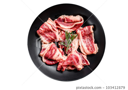 Raw beef bacon, marbled meat in a plate. Isolated on white background. Raw beef bacon, marbled meat in a plate. Isolated on white background. 103412879