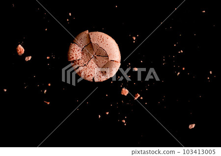 chocolate macaroon cracked and broken on a black background top view chocolate macaroon cracked and broken on a black background top view 103413005