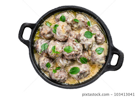 Beef meatballs in cream sauce in a frying pan. Isolated on white background. Beef meatballs in cream sauce in a frying pan. Isolated on white background. 103413041