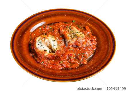 Roast hake white fish fillet with tomato sauce in a plate. Isolated on white background. Roast hake white fish fillet with tomato sauce in a plate. Isolated on white background. 103413499