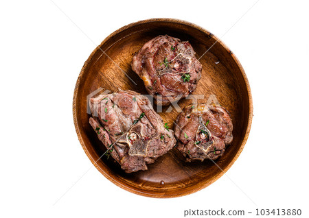Fried lamb neck meat steaks in a wooden plate with herbs. Isolated on white background. Fried lamb neck meat steaks in a wooden plate with herbs. Isolated on white background. 103413880
