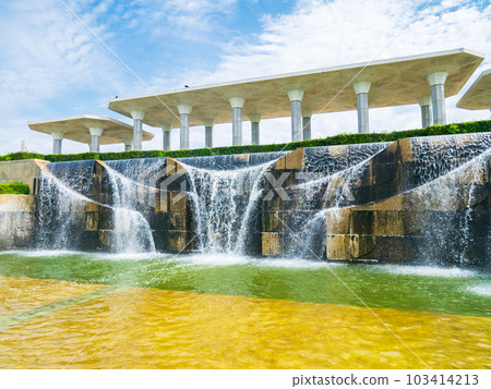 Artificial waterfall in the park, water rushing down 103414213