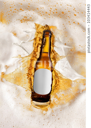 Bottle of delicious lager beer diving into foam of beer, splashes. Creative image for ad. Bottle of delicious lager beer diving into foam of beer, splashes. Creative image for ad. 103414443