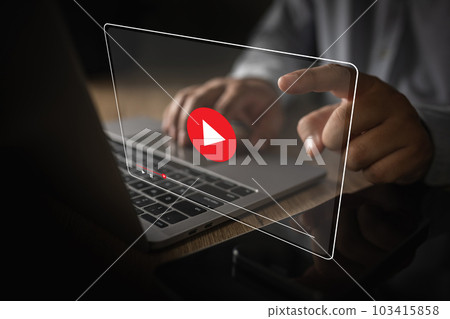 Man plays video media while watching a webinar on a laptop or screen technology interface communication call future meeting video 103415858
