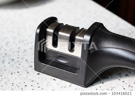 Black knife sharpener on the table closeup 103416021