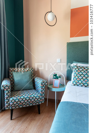 Fragment of a traditional bedroom with a chair for relaxation and a bed. horizontal format Fragment of a traditional bedroom with a chair for relaxation and a bed. horizontal format 103416777