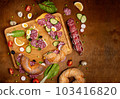 Set of fresh bagels with Salami, radish, cucumber. Top view. Wooden background 103416820