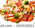 Salad with Prosciutto, tomatoes, onion, sweet pepper and broccoli. Cold snacks. Top view. Close up 103416821