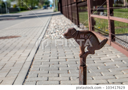 No dog pooing sign. Paved street, urban environment No dog pooing sign. Paved street, urban environment 103417629
