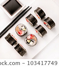 Sushi plate on white background, rolls set with vegetables on white background from above. Top view of traditional japanese cuisine. Asian food with chopsticks design. 103417749
