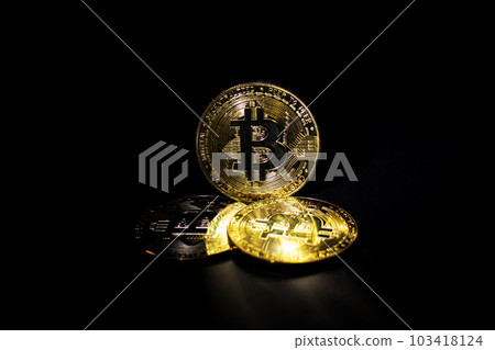 A stack of bitcoins shines in the dark A stack of bitcoins shines in the dark 103418124