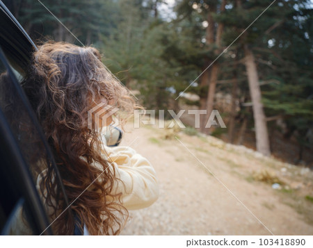 Woman on road trip traveling by rental car Woman on road trip traveling by rental car 103418890