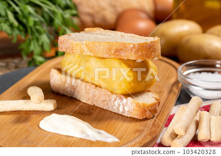 Spanish omelette with potatoes and onion, typical Spanish cuisine. Tortilla espanola. Rustic dark background 103420328