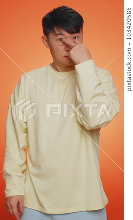 Asian man pointing at his eyes and camera, show I am watching you gesture, spying on someone Asian man pointing at his eyes and camera, show I am watching you gesture, spying on someone 103420585