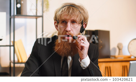 Businessman wearing headset, office freelance worker, call center, support service operator helpline Businessman wearing headset, office freelance worker, call center, support service operator helpline 103420621