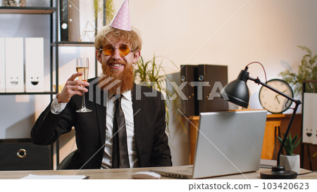 Young businessman dancing victory dance celebrating start of weekends holiday success win in office 103420623