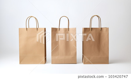 Three cardboard recycled shopping bags. Brown kraft paper mockup packaging eco retail carry bag close up focus photo 103420747