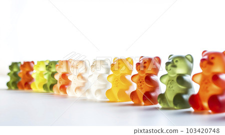 Bright gummy bear candy in a row. Various colors taste sugar sweet kids dessert. Gelatin gum jelly soft glowing bears close up focus photo 103420748