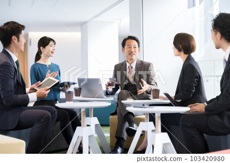 A business scene of a company with a clean office building, where the president and managers talk to their subordinates, with copy space A business scene of a company with a clean office building, where the president and managers talk to their subordinates, with copy space 103420980