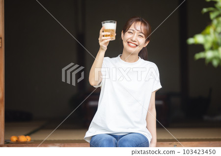 Woman drinking beer 103423450