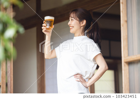 Woman drinking beer 103423451