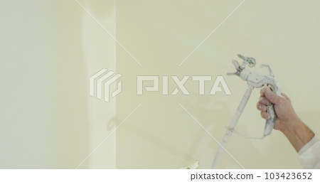 Close up of man painter paints the walls with paint spray gun. Airless spray painting. Close up of man painter paints the walls with paint spray gun. Airless spray painting. 103423652