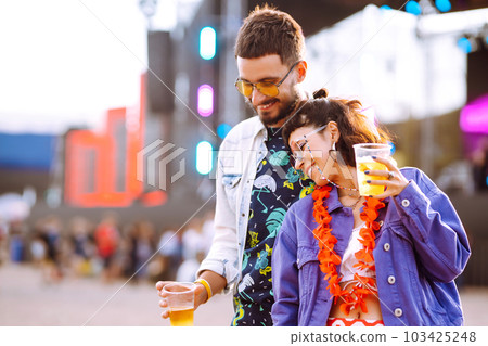 Group of friends with beer dancing and having fun at music festival together. Summer Beach party. Group of friends with beer dancing and having fun at music festival together. Summer Beach party. 103425248