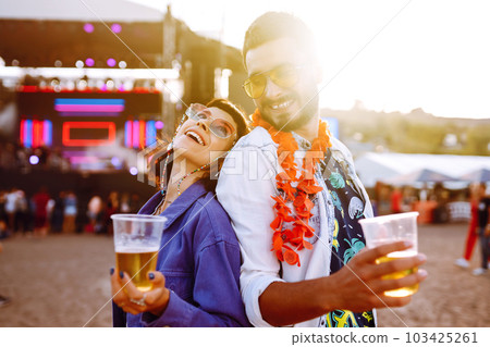 Couple with beer at music festival. Summer Beach party, holiday, vacation concept. Couple with beer at music festival. Summer Beach party, holiday, vacation concept. 103425261