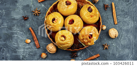 Baked autumn apples with nuts and raisins 103426011