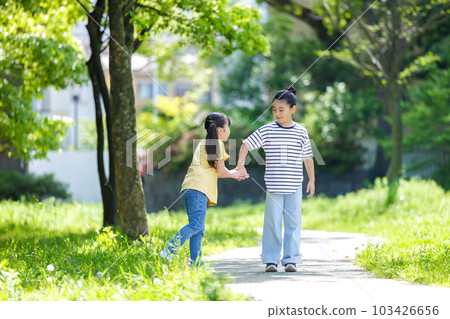 Children walking along the green road Children walking along the green road 103426656