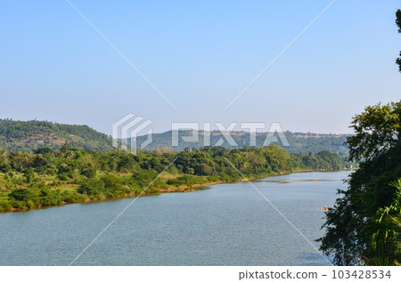 River with lush green coconut palms on the banks River with lush green coconut palms on the banks 103428534
