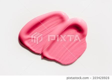 Smears of creamy pink lip gloss or eye shadow on a white background 103428928