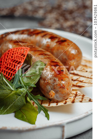 Grilled tasty bratwurst sausages on the plate 103429861