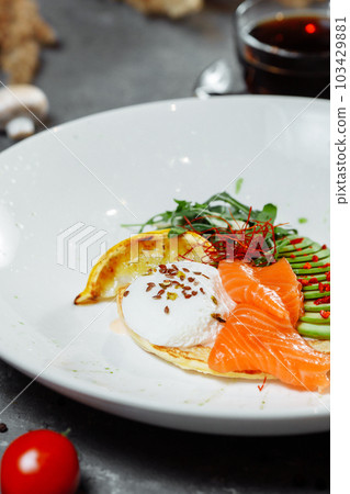 Summer healthy fastfood lunch, breakfast with Pancake with red fish, avocado and egg for breakfast. Aesthetic still life, healthy food concept 103429881